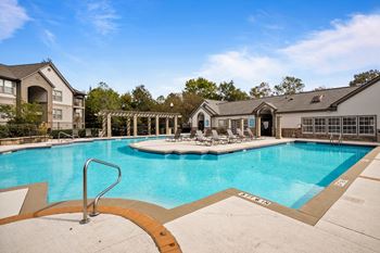our apartments have a resort style pool with lounge chairs  at 150 Summit, Birmingham, AL, 35243